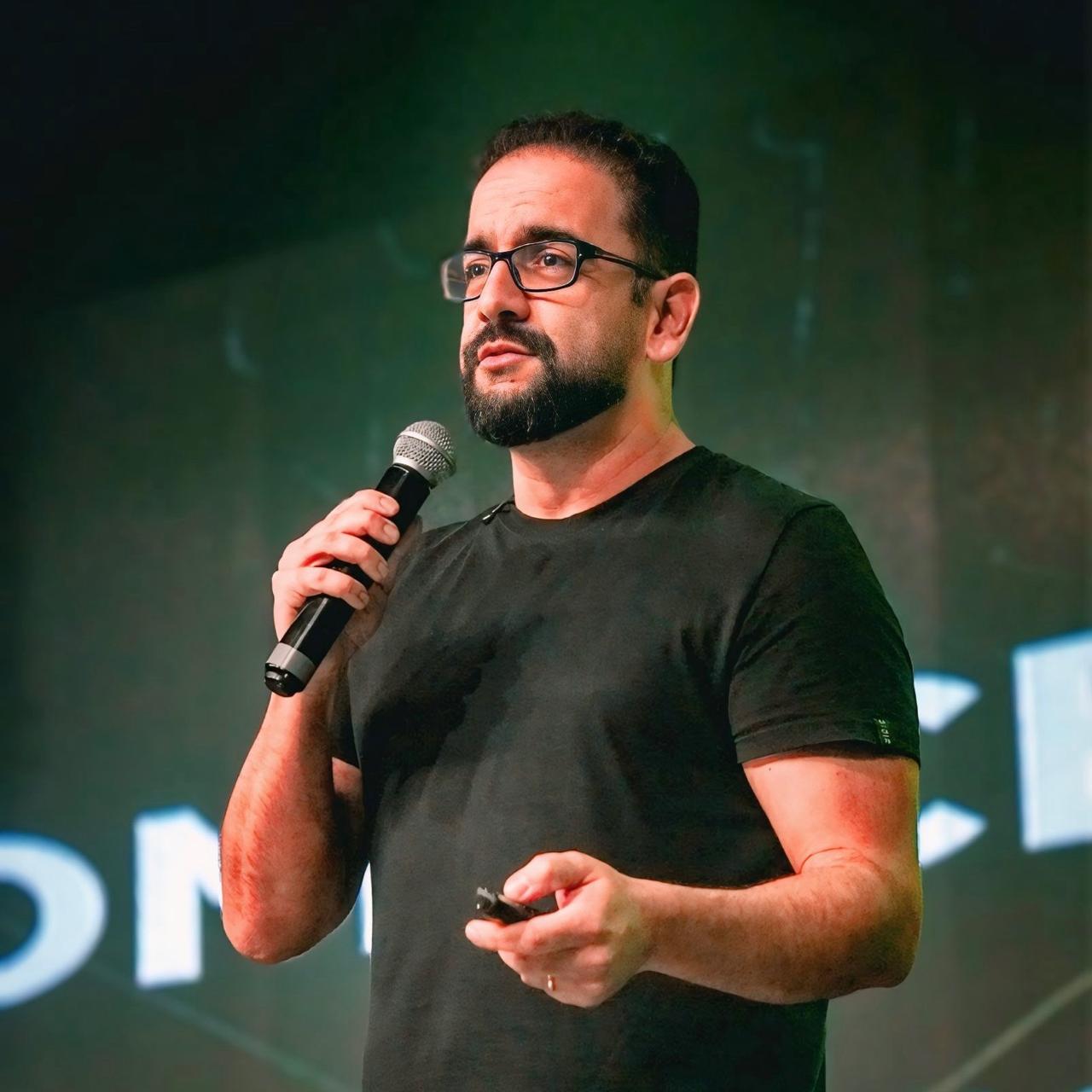 Alexandre Viveiros palestrando com microfone